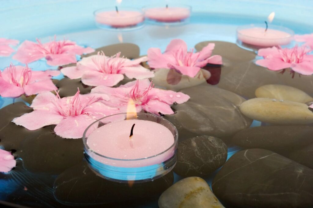 lily pads and a candle floating on water