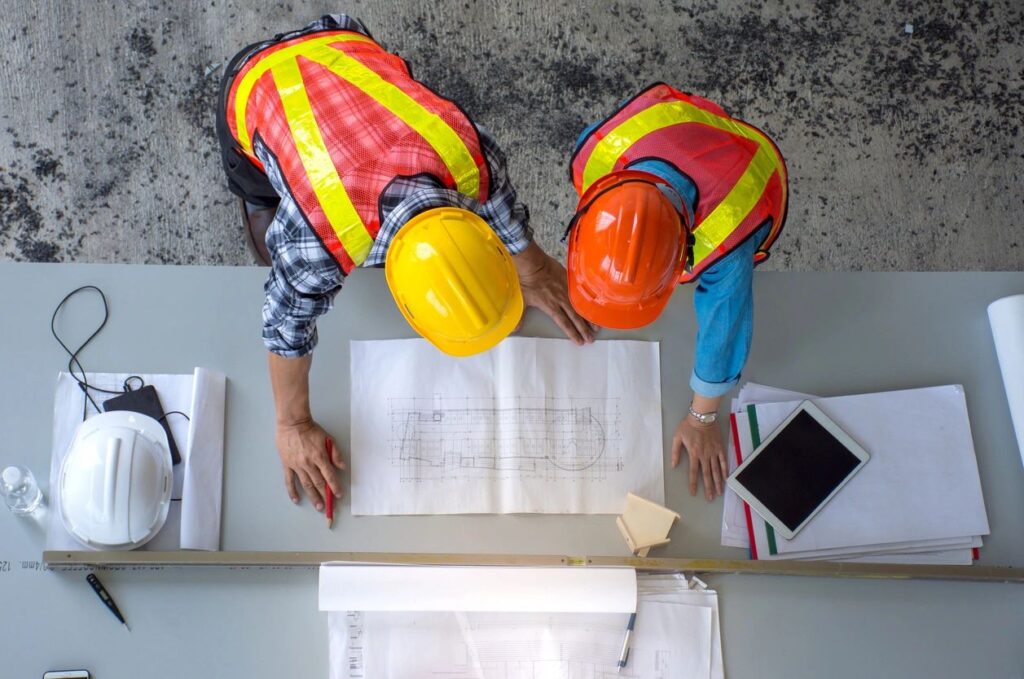 construction workers looking at a building design plan